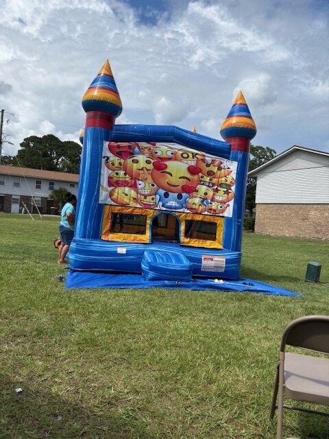 A bouncy house outside in the grass.